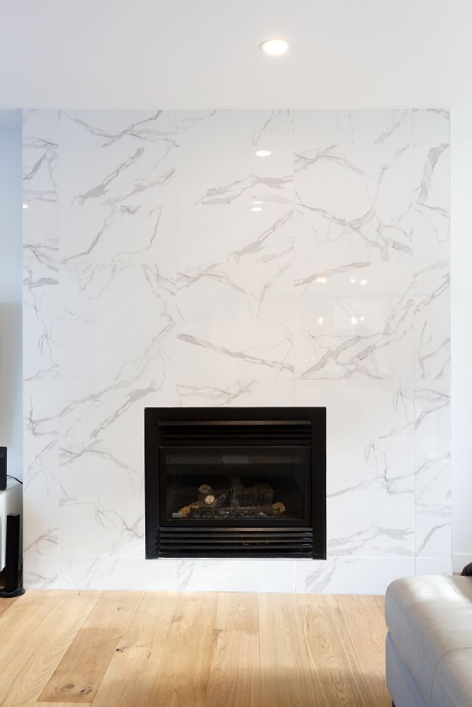 Custom fireplace with full-height marble front and clean modern detailing.