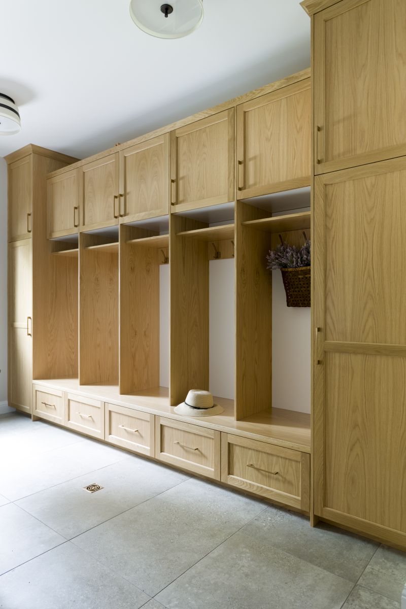Modern mudroom design with wood lockers, bench seat, and integrated storage for coats and shoes