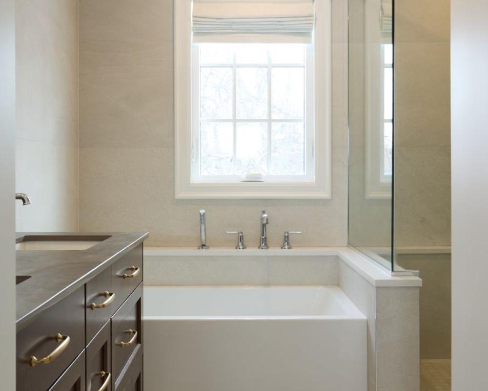 Custom luxury ensuite bathroom with deep soaking tub