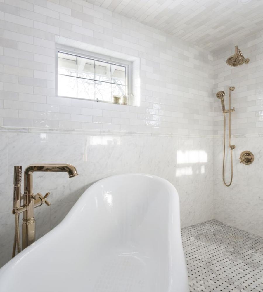 Custom bathroom with deep clawfoot tub and timeless wall tile