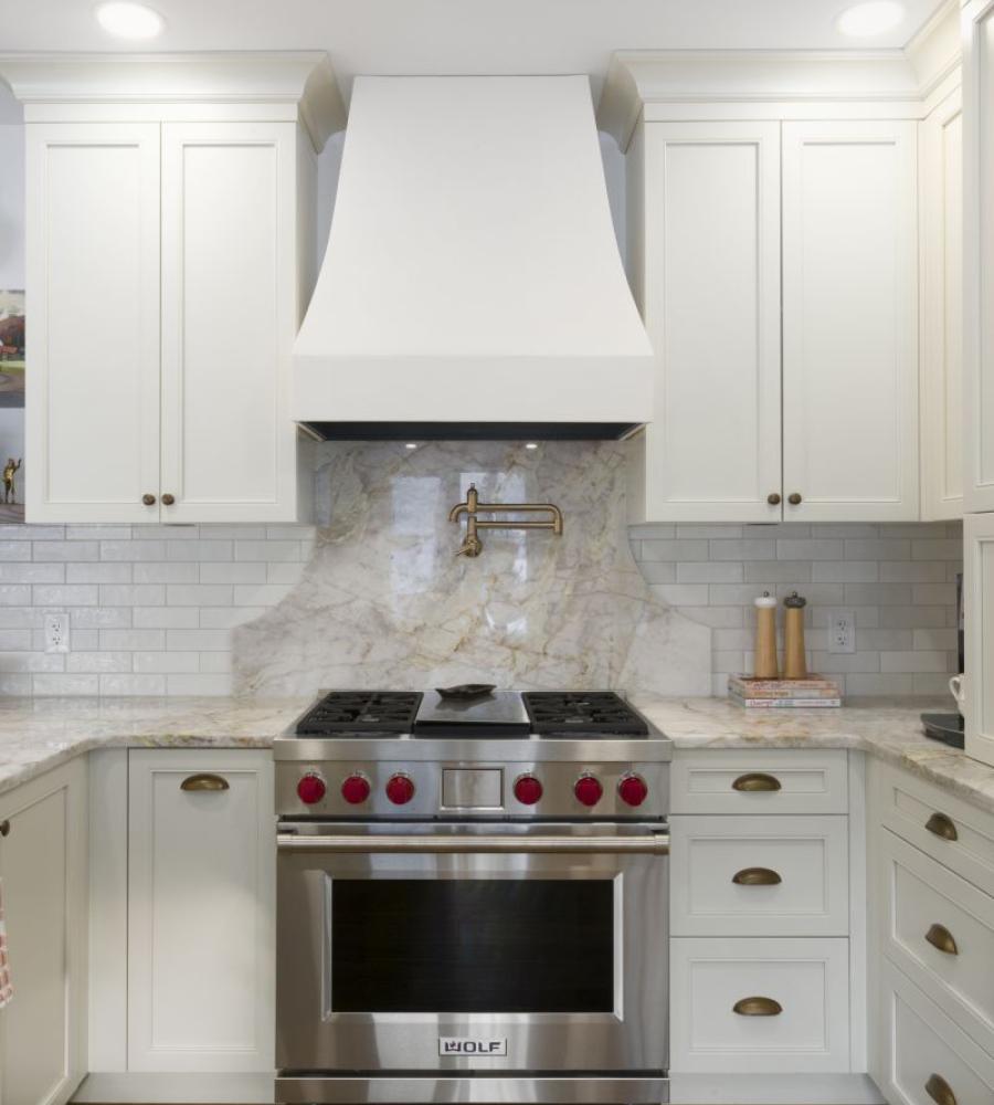 Bold kitchen backsplash with pot filler above stove