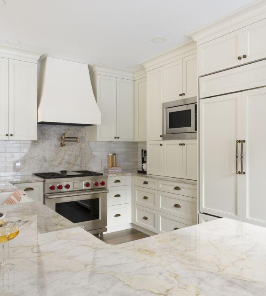 Cream colored cabinetry with panel ready fridge