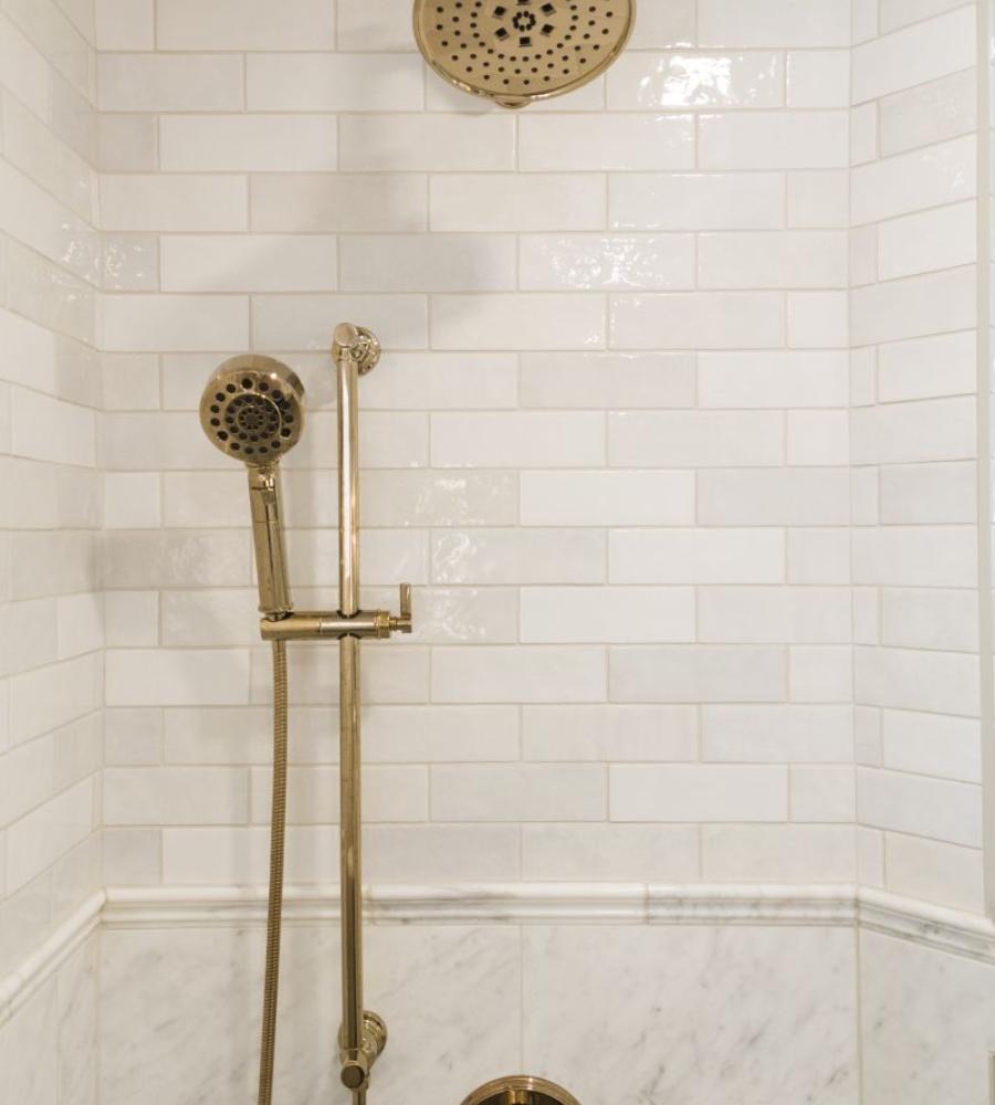 Champagne bronze shower head with timeless wall tile